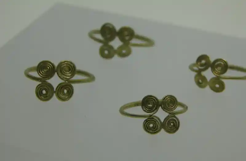 A gold finger ring with four spirals